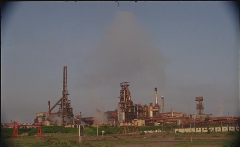 Factories sit under a blue sky