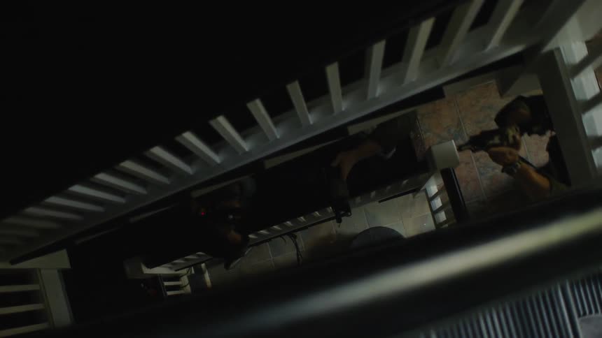 A swat team climbs up a stairwell