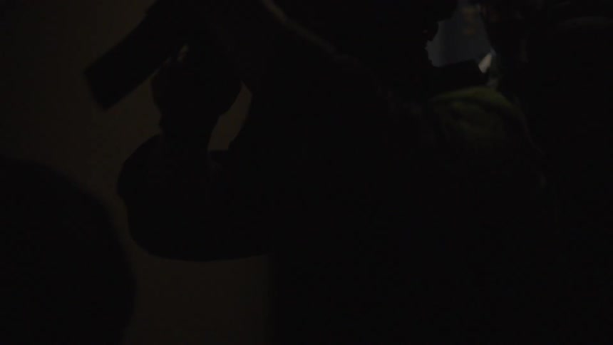 A swat team is doing a raid on a house