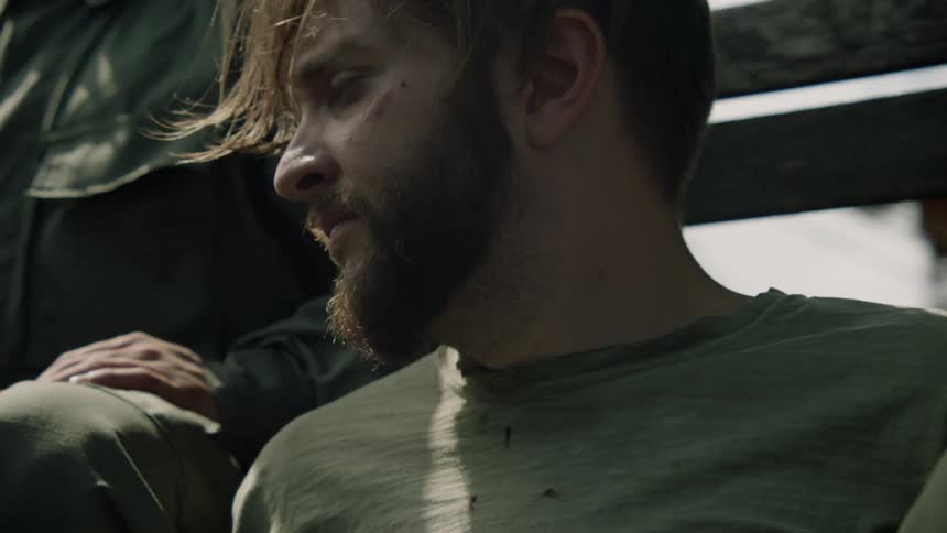 A man is riding in the back of a truck