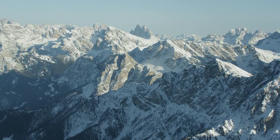 The large mountain range is covered with ice and snow
