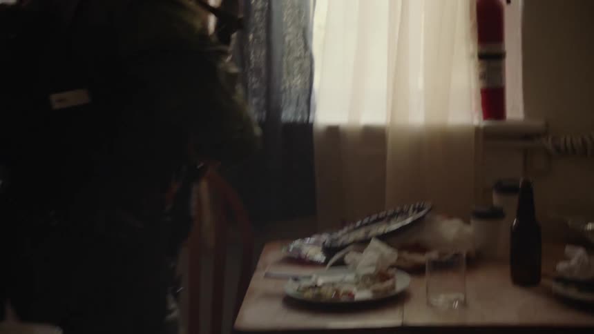 A police officer searches a home