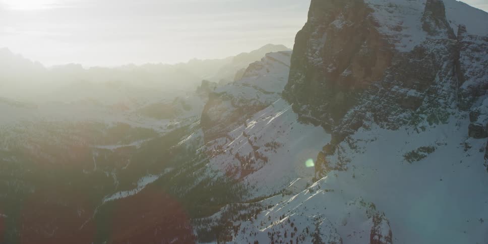 Moving around the mountain as the sun sets in the distance