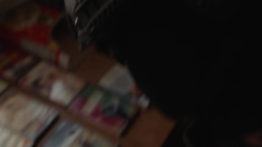 A police officer is taking pictures of evidence inside a home in daylight