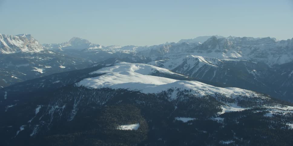 Mountain range covered in snow and trees