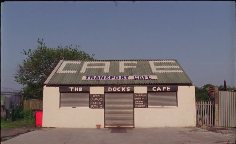 The building has cafe painted on the roof