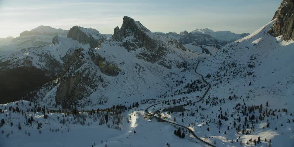 The sun shines over snowy mountains