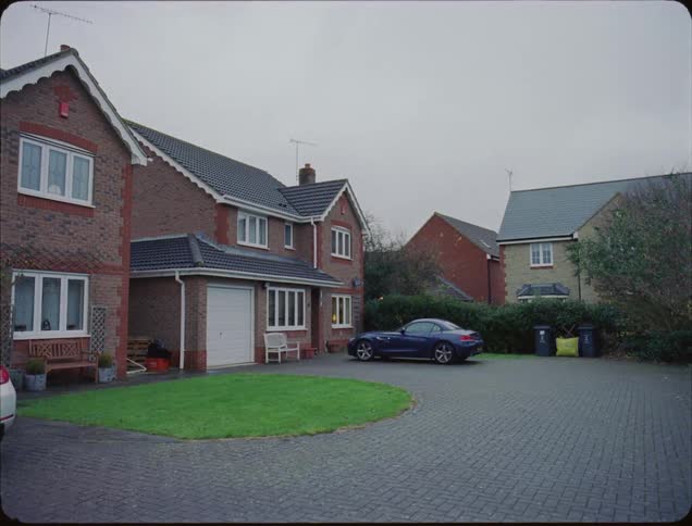 A car is parked in front of a house