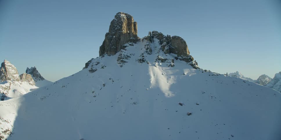 The rocks barely reach above the hills of snow