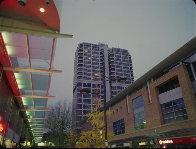 The tall building is at the end of the block