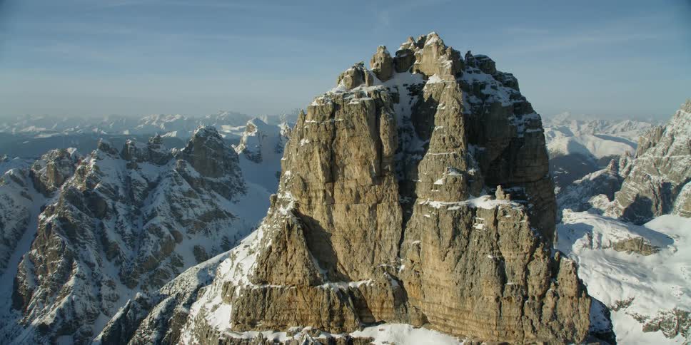The tall mountain reaches into the cloudy sky