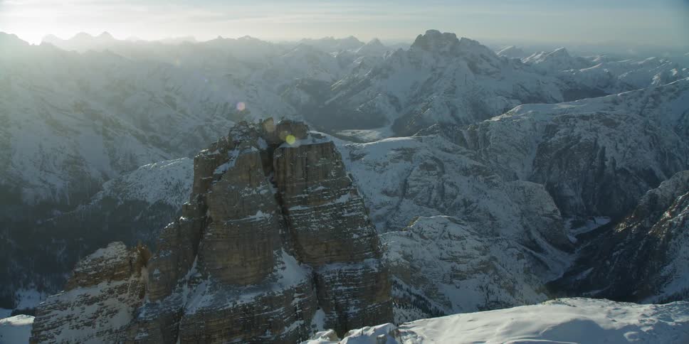 Snow covers jagged ridges and mountains