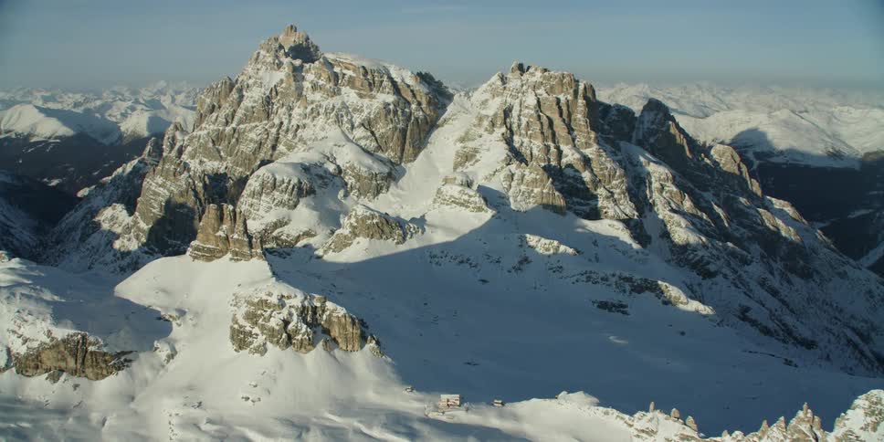 Snow covers rocky mountain peaks