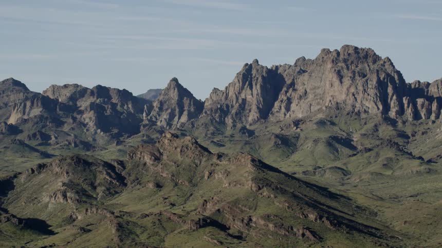 Rare green vegetation covers the desert mountain range