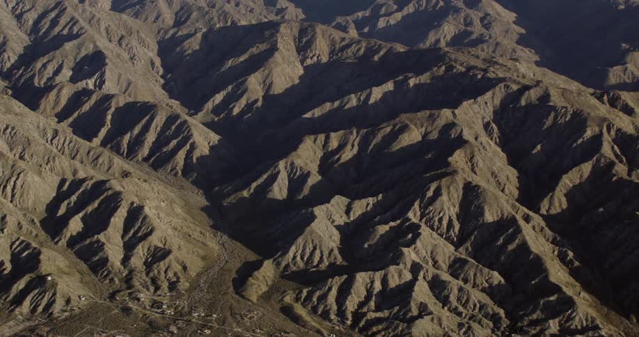 Mountains cast shadows in the desert