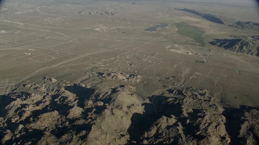 Aerial tilt to reveal desert landscape and mountains