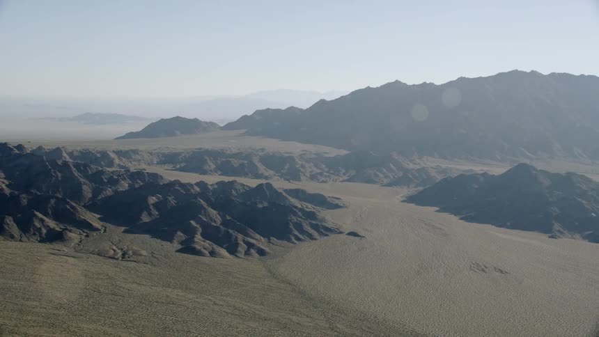 Aerial views of an empty barren desert mountain landscape