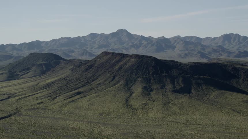 Black volcanic mountains covered in green vegetation