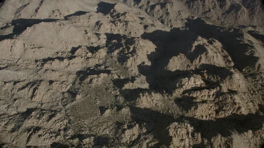 Boulder piles in Josua Tree National Park cast shadows at sunset