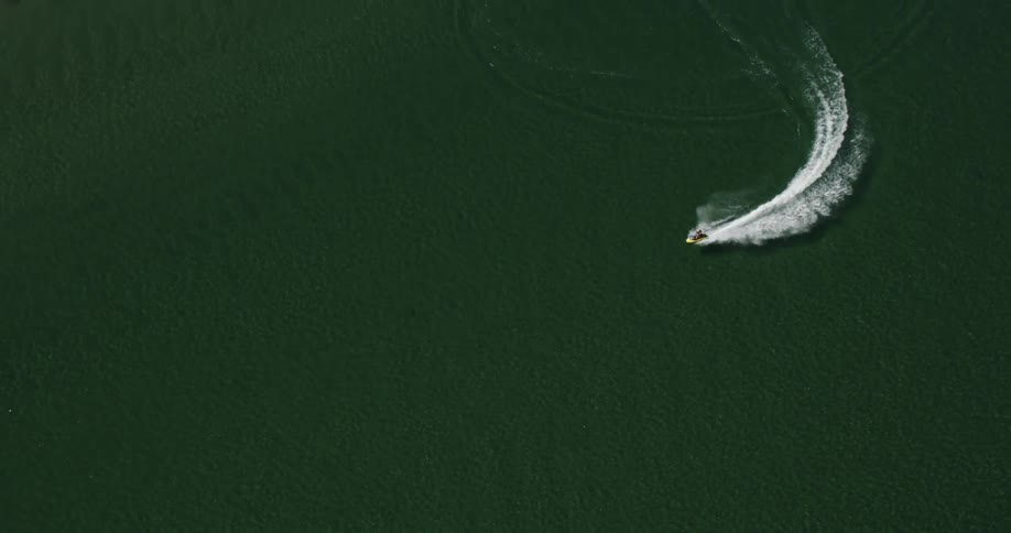 Birds Eye view of jet ski racing in slow motion