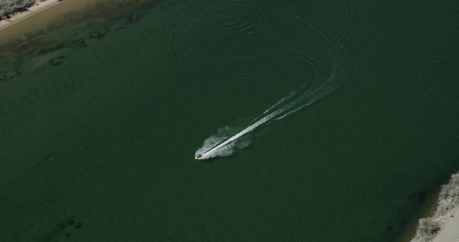 Aerial birds eye view of jet ski in slow motion
