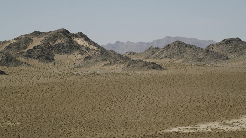 Mountains rise up from the barren desert