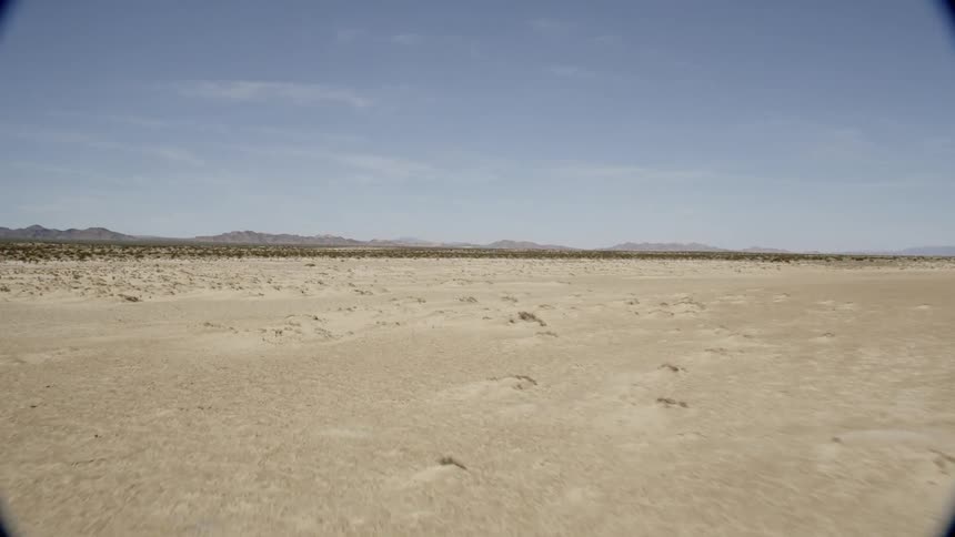 Flat desert land under a clear sky
