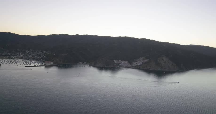 Aerial view of a shoreline with mountains behind it