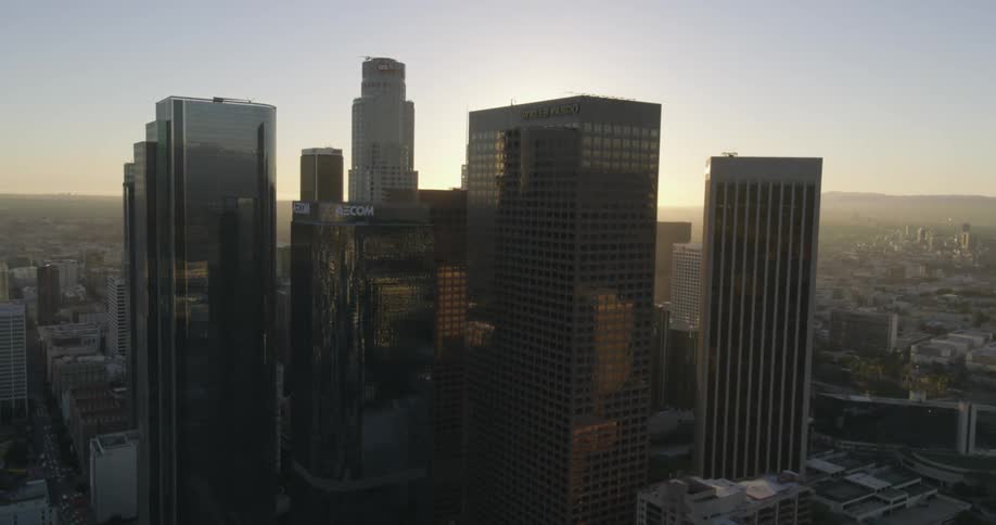 A city has many tall buildings at sunset