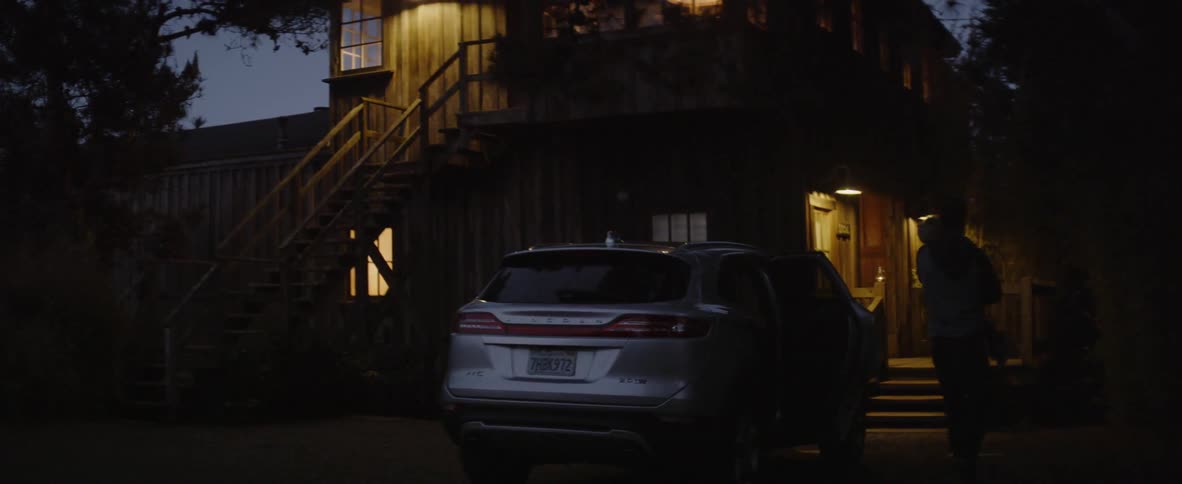 A family walks into their house at night