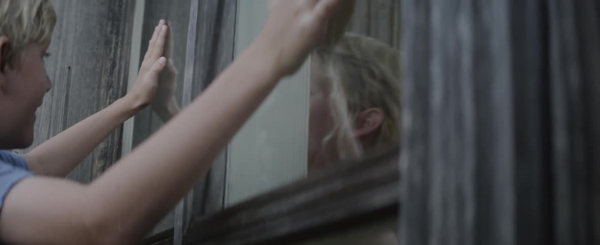 Children laugh and play through the glass windows