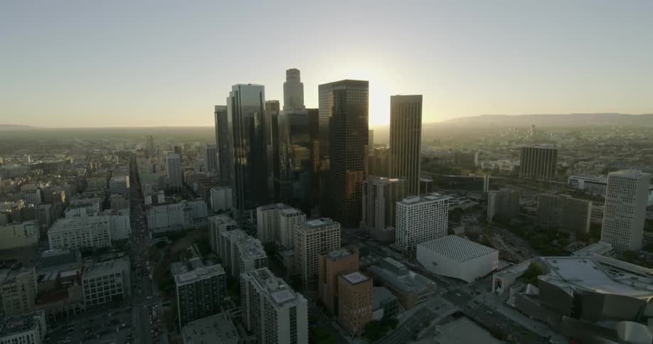 The sun is setting in the distance of this large city