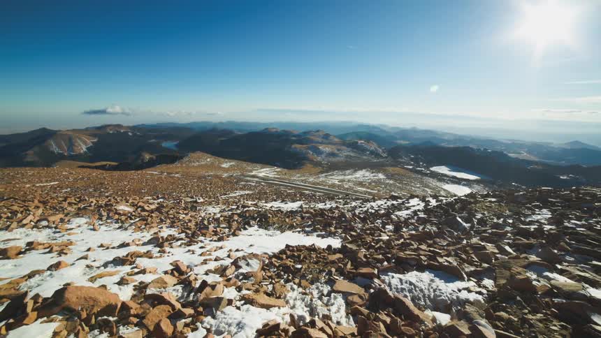 A bunch of rocks are covered in snow