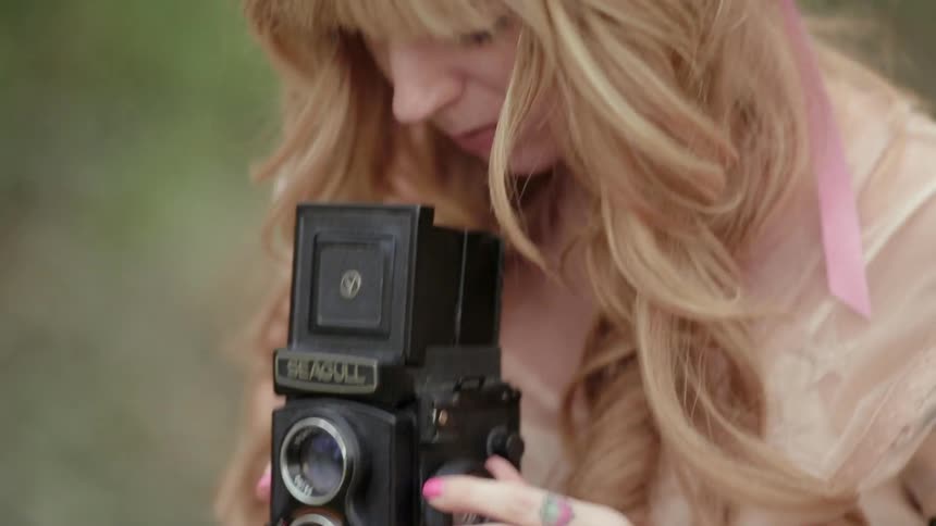 A woman is taking vintage photos