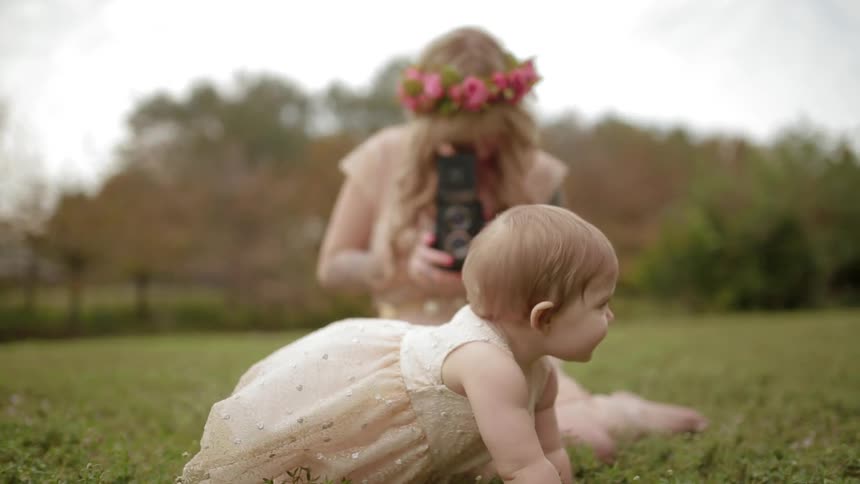 A person taking pictures of a baby