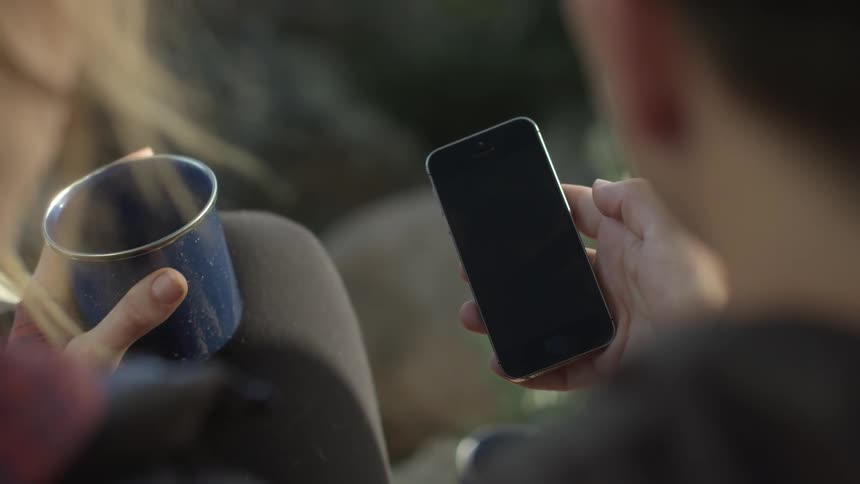 A man plays with his phone