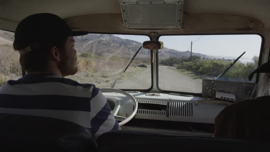 Man driving a vehicle with a person sitting in the passenger side