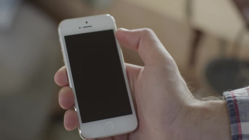 A phone is being played with by a man