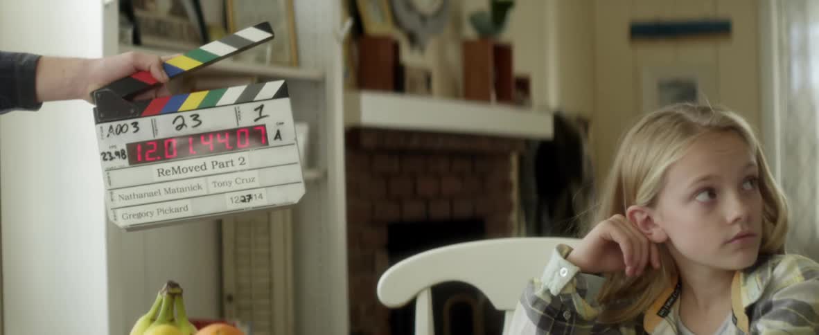 A child is being filmed at the table