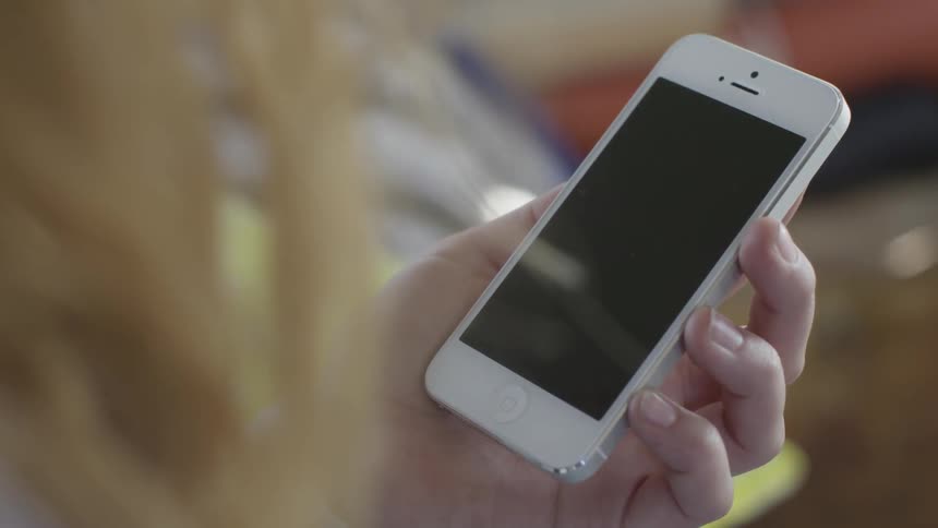 Hand holding a white phone