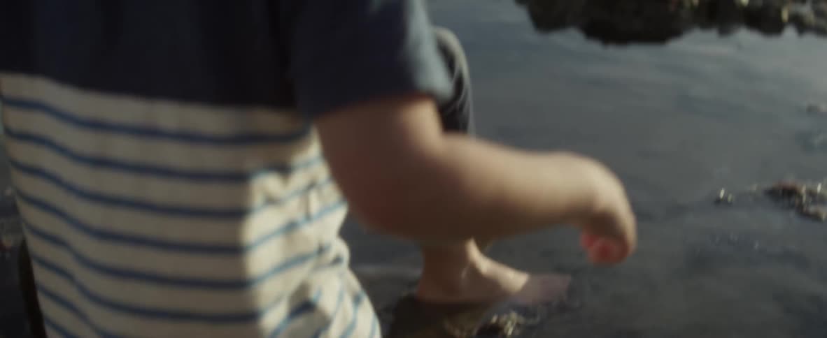 Kids play in shallow water on the beach