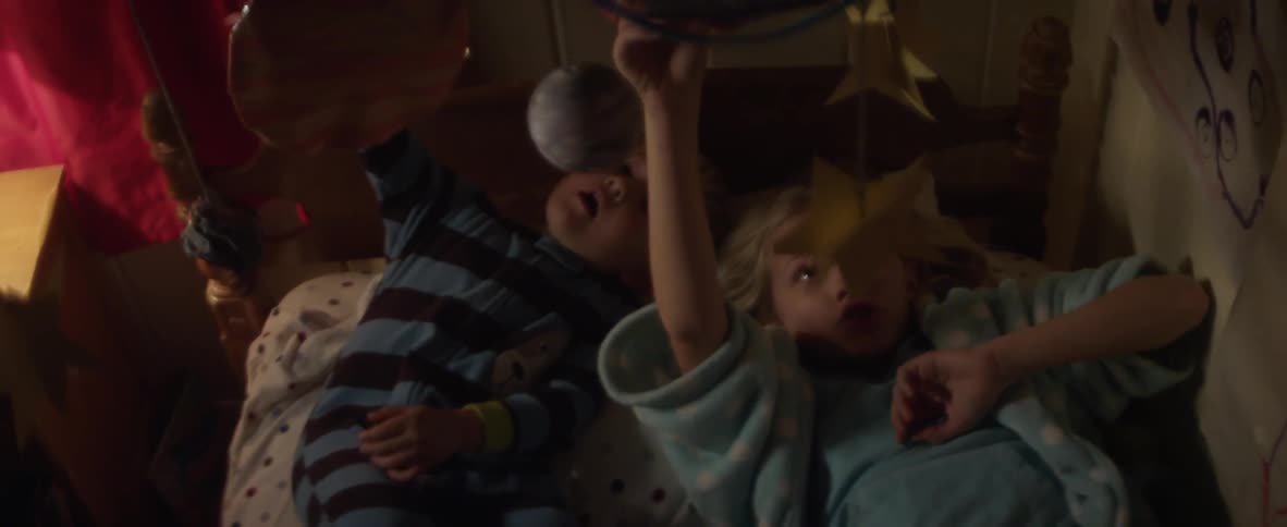 Children playing with toys in a bed