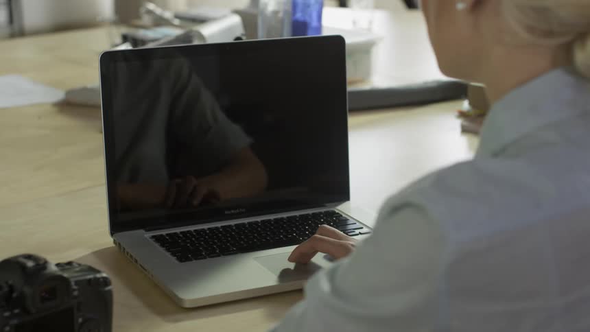 A woman is sending an email