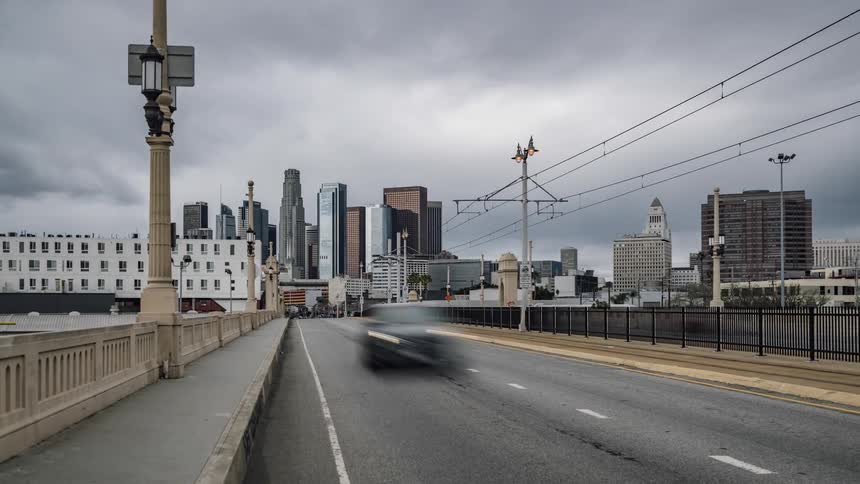 Vehicles travel over a city bridge