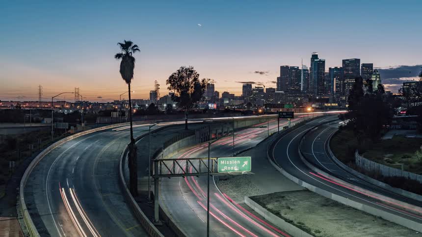 City traffic on a highway as day turns to night