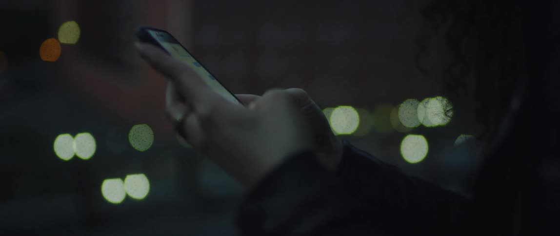 A woman uses a cell phone outside