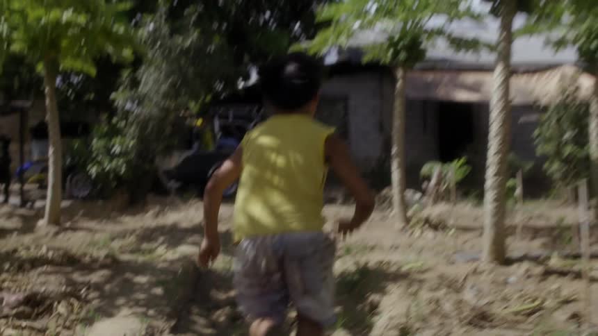 A man runs through the yard towards the house
