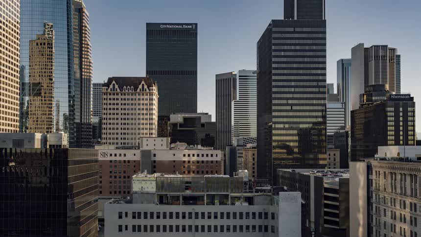 The buildings are all lit up at dawn