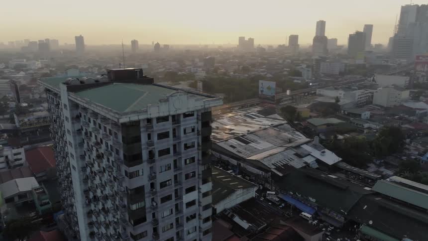 The sun sets over city buildings