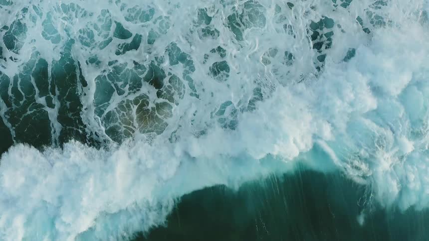 Waves build and crash onto the shore
